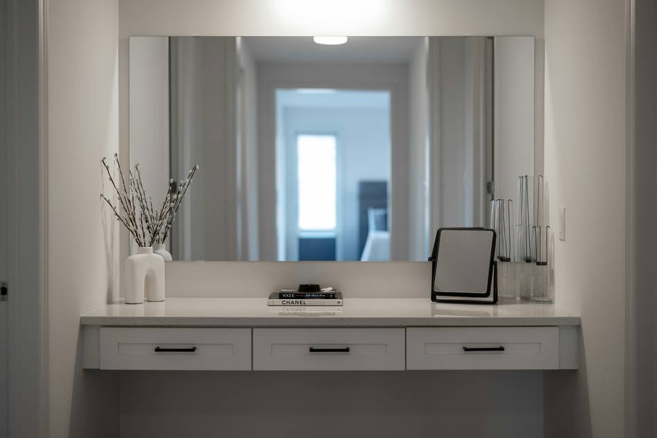 Founder of Mirror Muse holding a ring-light makeup mirror in a well-lit studio