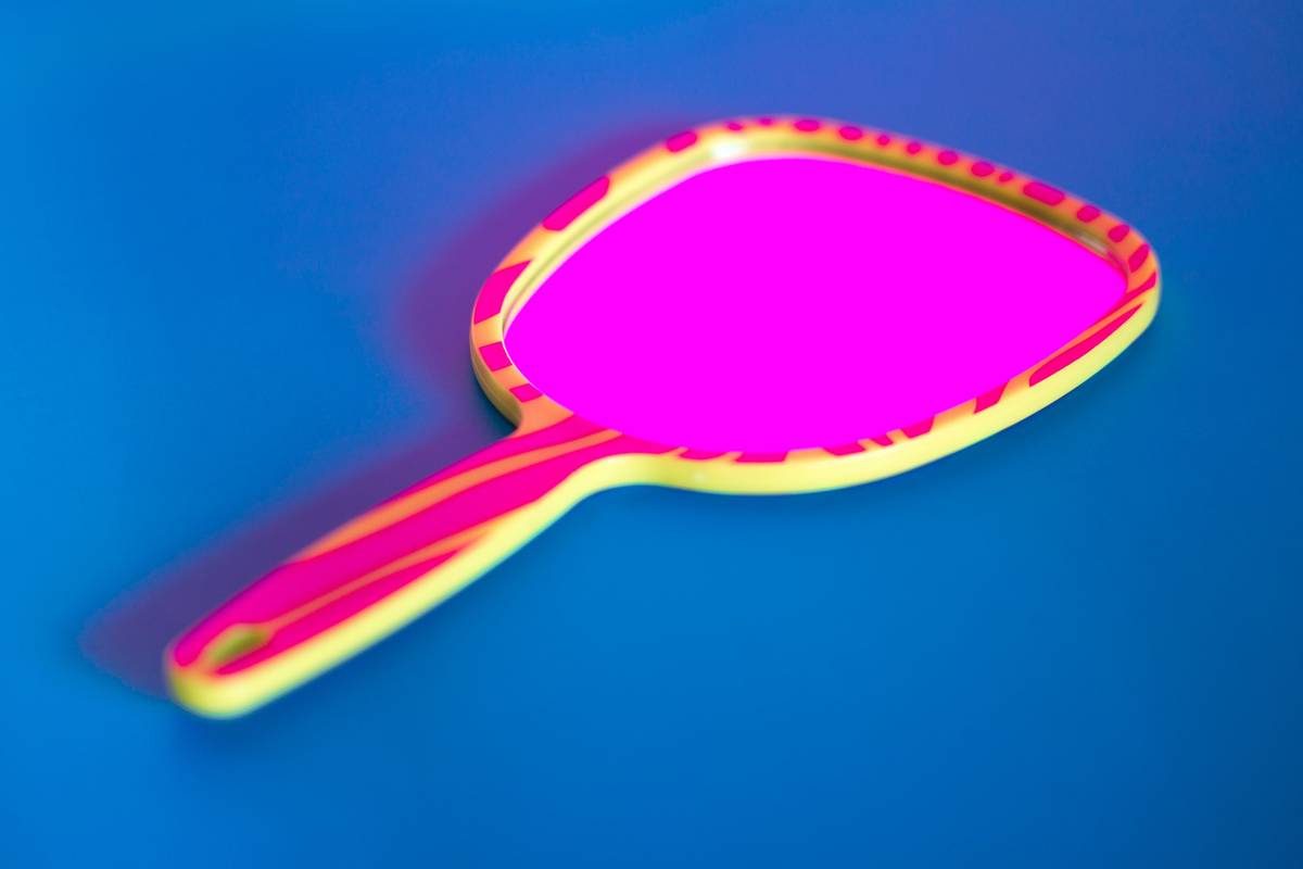 makeup application aid showing a magnified view of blended foundation under neutral LED lighting