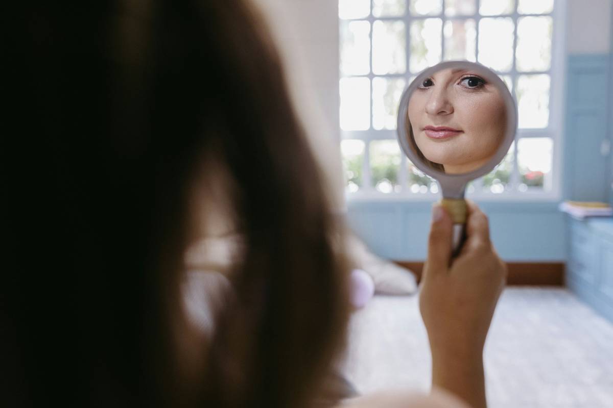 a woman looking at herself in the mirror